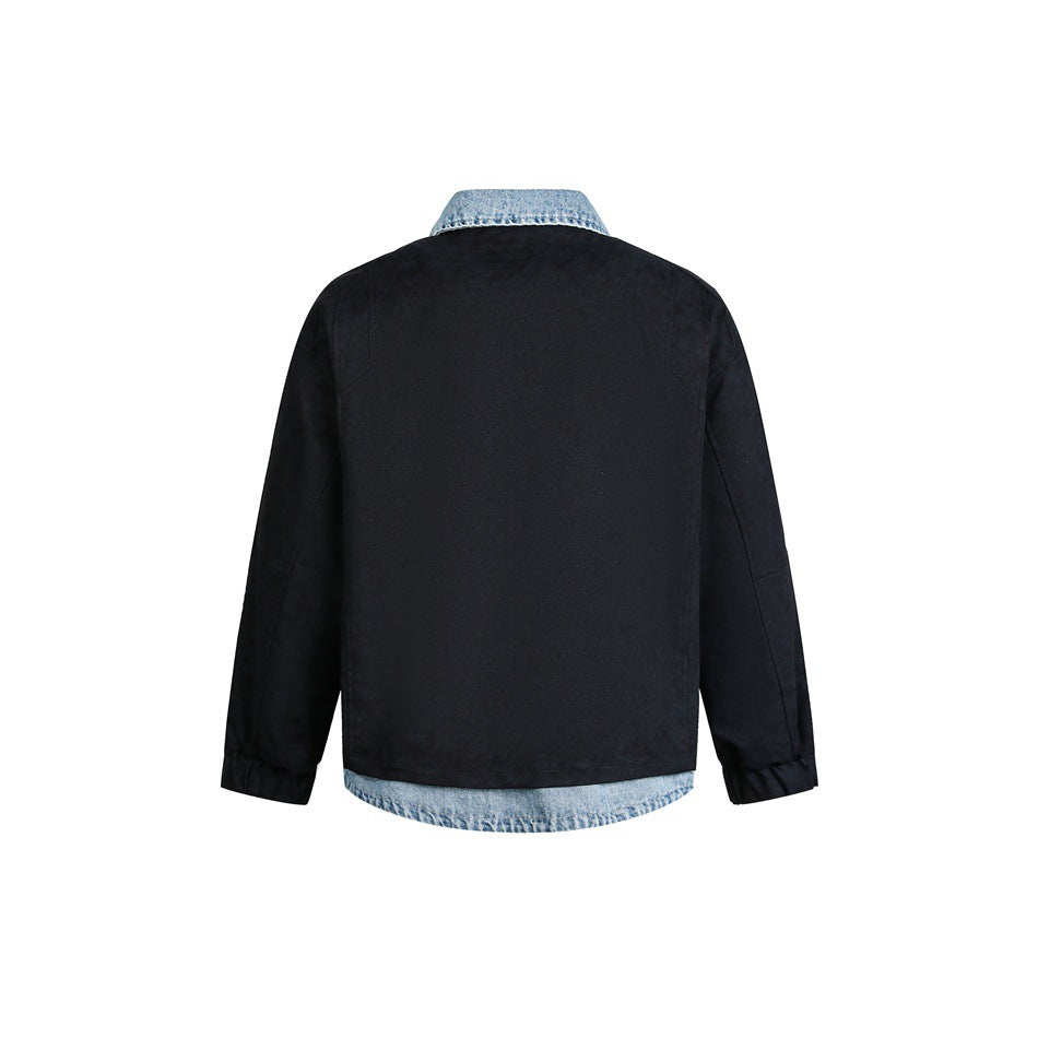 Back view of a black jacket with a blue denim collar and curved denim hem.