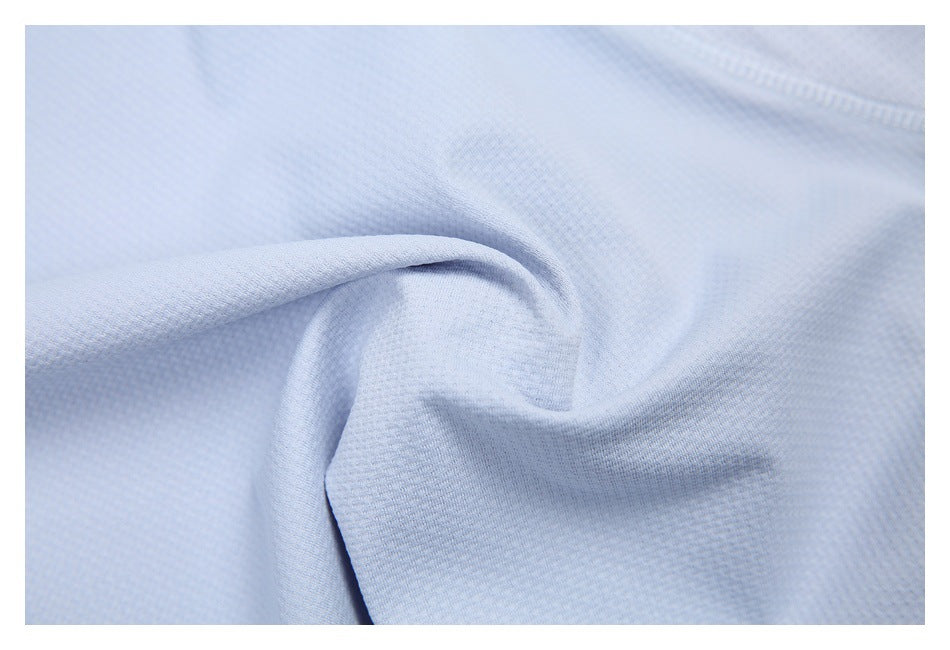 Close-up of light blue shirt fabric gathered to show its textured surface.