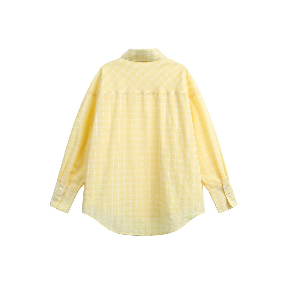 Flat lay of a pale yellow windowpane-check shirt, showing its back, collar, long sleeves and curved hem.