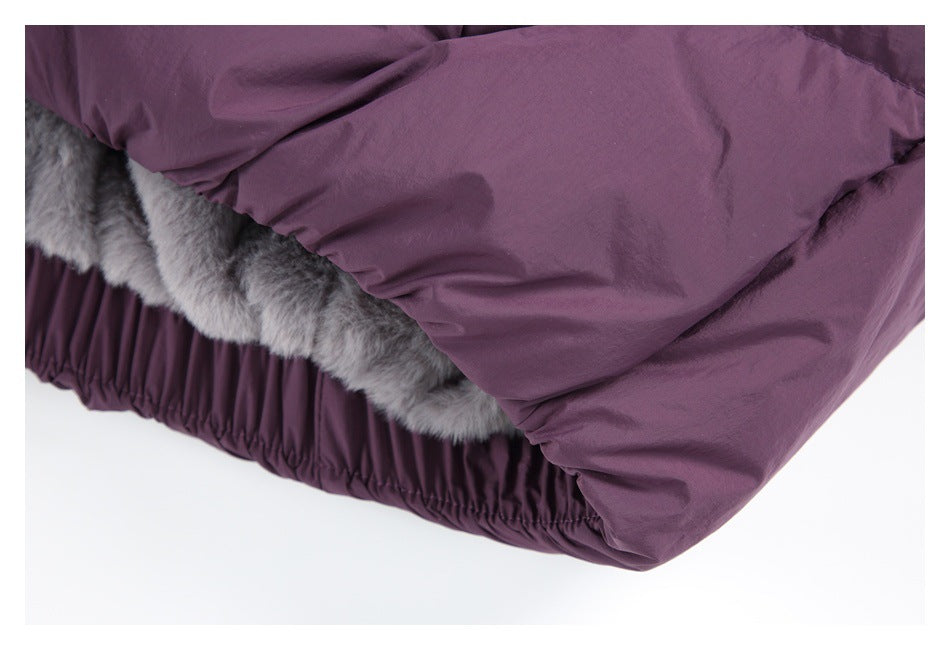 Close-up of the plum-purple jacket hem, showing gray faux-fur lining and a gathered edge.