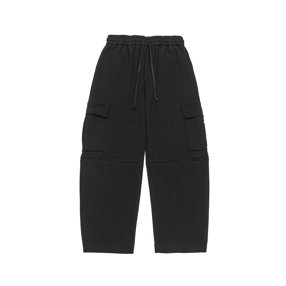 Black wide-leg cargo pants with elastic drawstring waist and large side flap pockets, flat front view