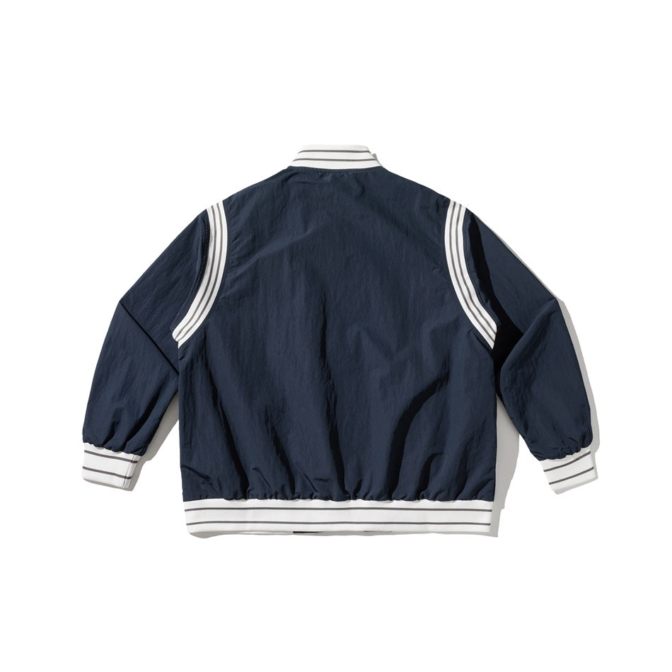 Back view of a navy jacket with white striped rib trim and curved white shoulder panels.