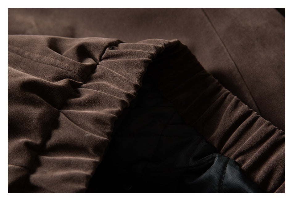 Close-up of a dark brown garment opening, gathered trim, and black quilted lining.
