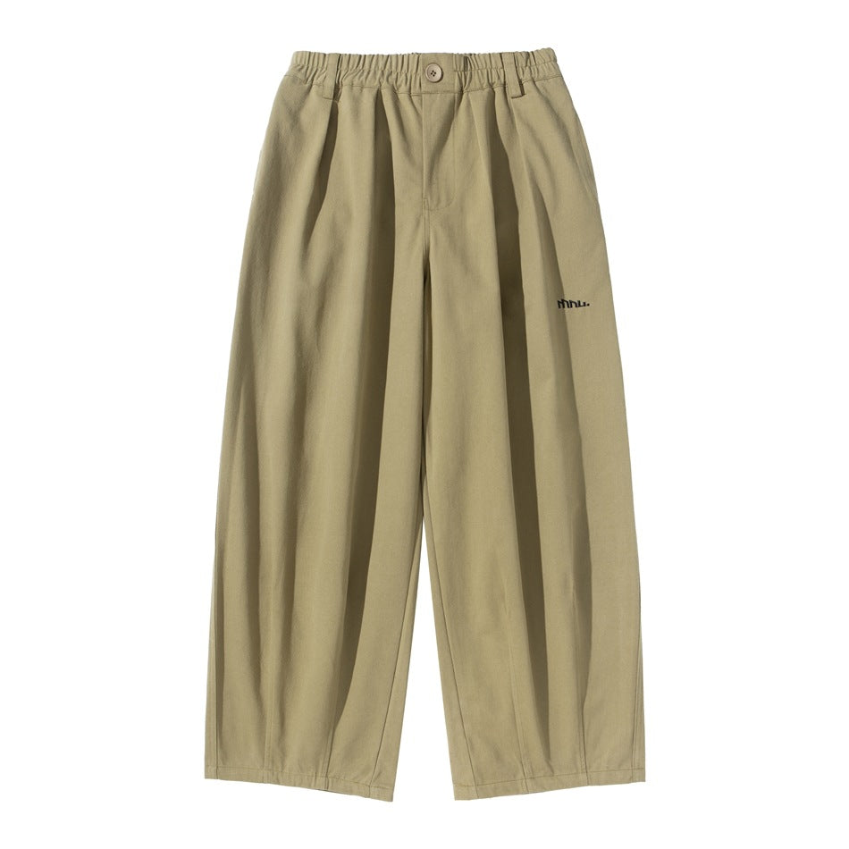 Khaki wide-leg pleated pants with elastic waistband, button front and small embroidered logo, flat front view
