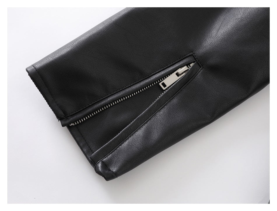 Close-up of a black jacket sleeve cuff with an open silver zipper.