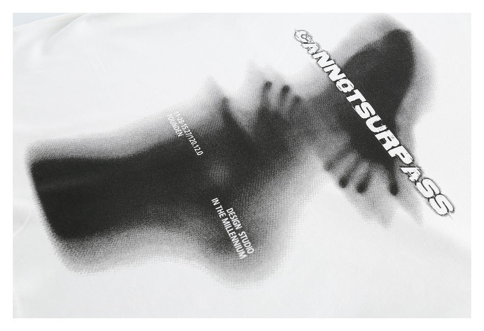 Close-up of a white garment with a black-and-gray graphic, bold English lettering, and smaller text.