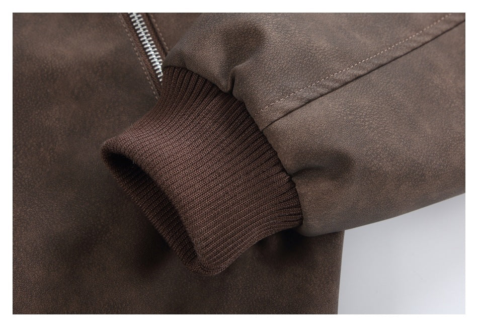 Close-up of the brown jacket's rib-knit cuff and sleeve seam.