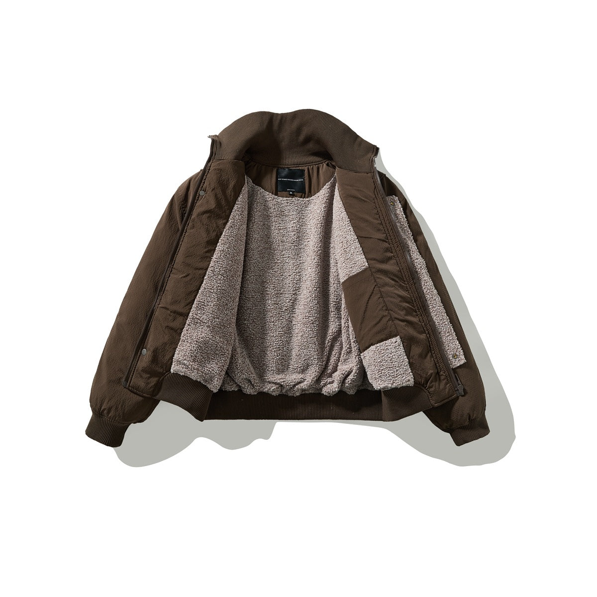 Brown zip-front jacket opened to show its light taupe textured lining and dark ribbed collar, cuffs, and hem.
