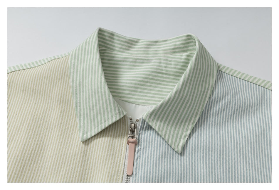 Close-up of the jacket's wide striped collar and front zipper with a pink pull.