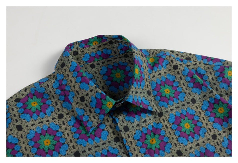 Close-up of a button-up shirt collar in a gray, blue, purple, and green floral geometric print.