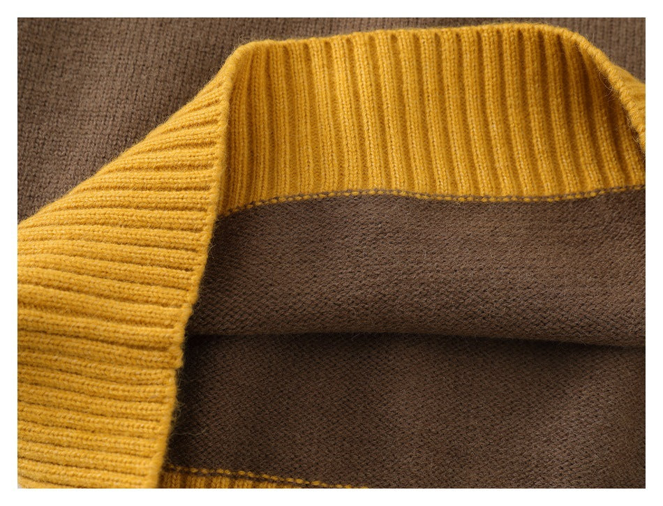 Close-up of brown knit fabric with a mustard-yellow ribbed edge and visible stitching.