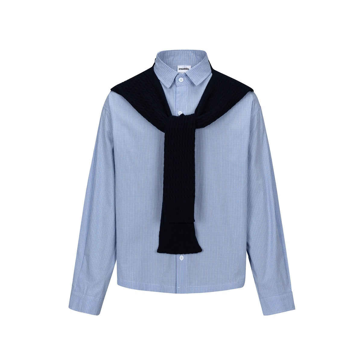 Front view of a light blue checked button-up shirt styled with a dark navy cable-knit scarf draped over the shoulders.