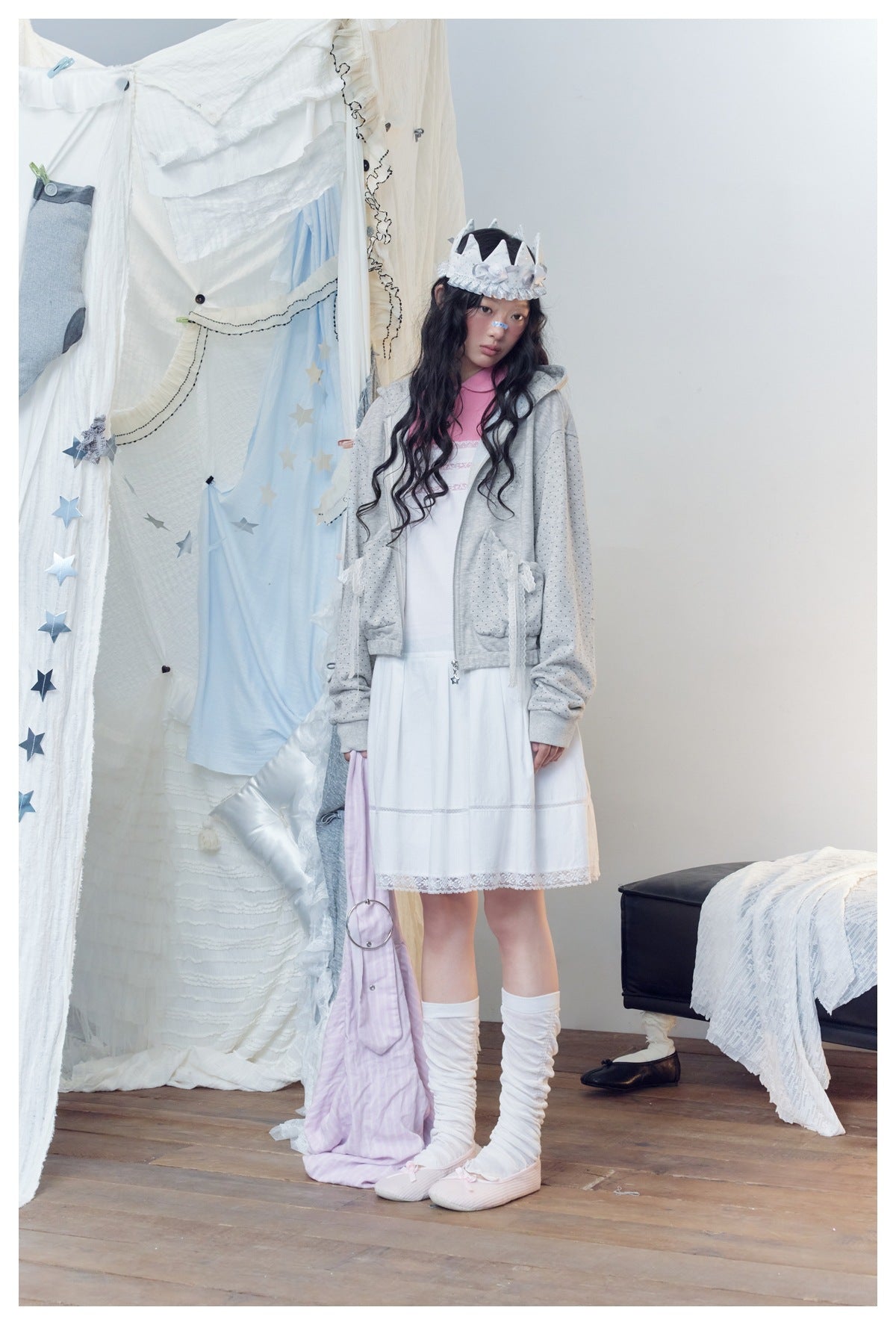 Full-length model in a light gray dotted hoodie over a white dress with a pink collar and lace hem.
