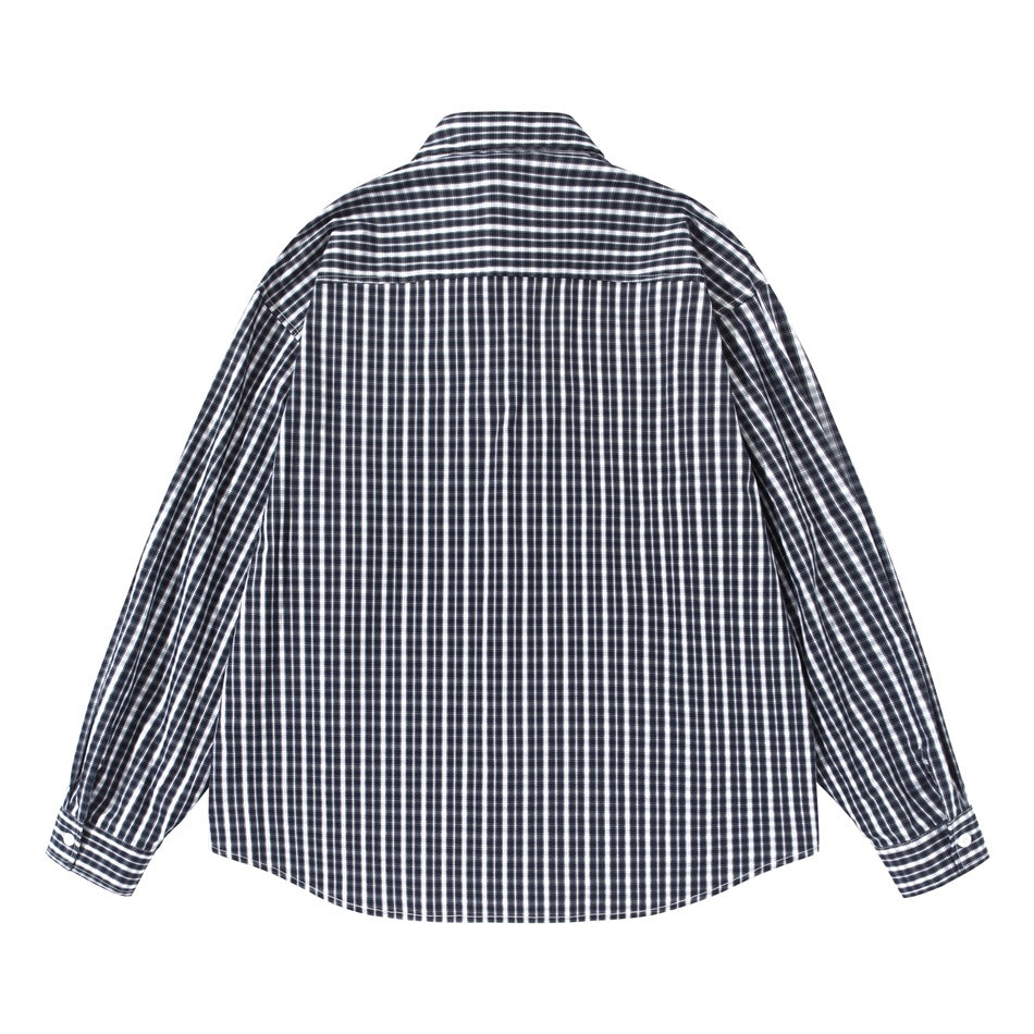 Back view of black and white plaid long-sleeve shirt with horizontal-check yoke and buttoned cuffs