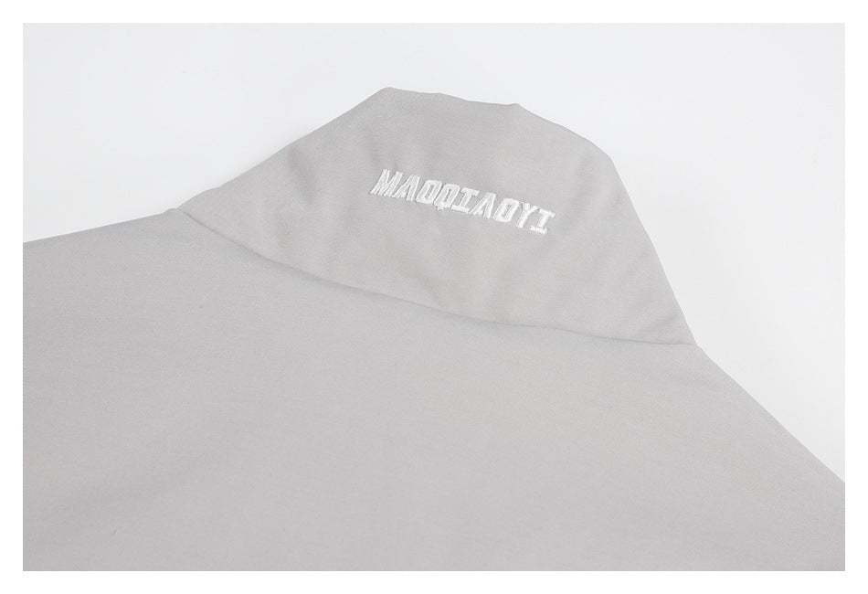 Light gray jacket collar with white embroidered lettering.