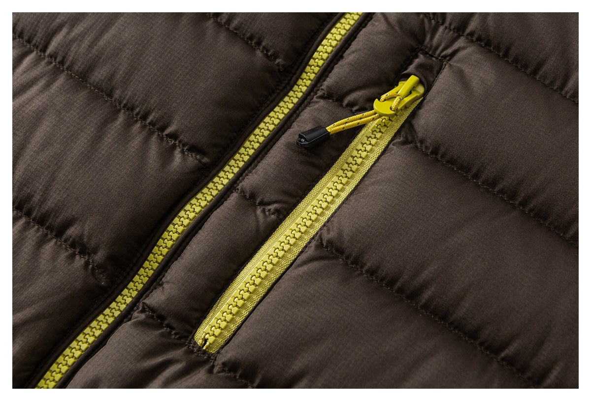 Close-up of brown quilted jacket fabric with a bright yellow main zipper and matching zip pocket.