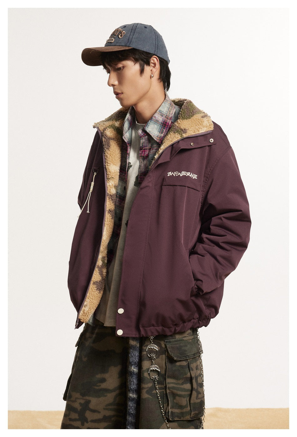 Side view of a model wearing an open burgundy jacket with camouflage fleece lining and a chest pocket.