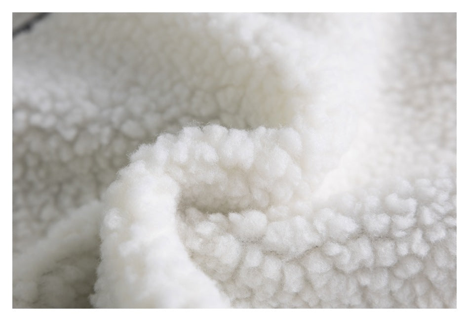 Macro view of the thick, curly white sherpa lining.