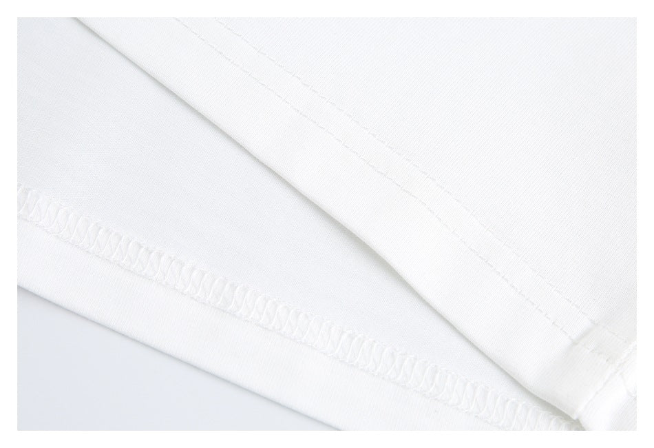 Close-up of white shirt fabric showing a folded edge and overlocked hem stitching.