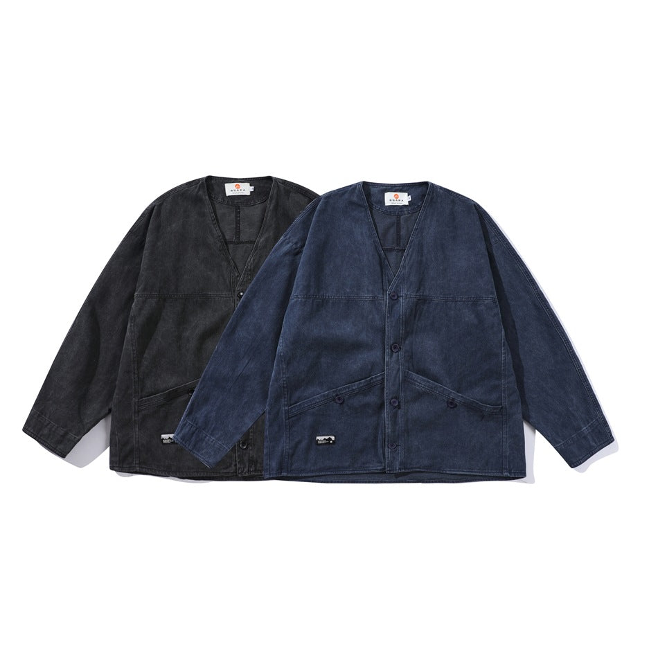 Two V-neck indigo work jackets shown from the front, one charcoal black and one dark blue, with buttons and patch pockets.