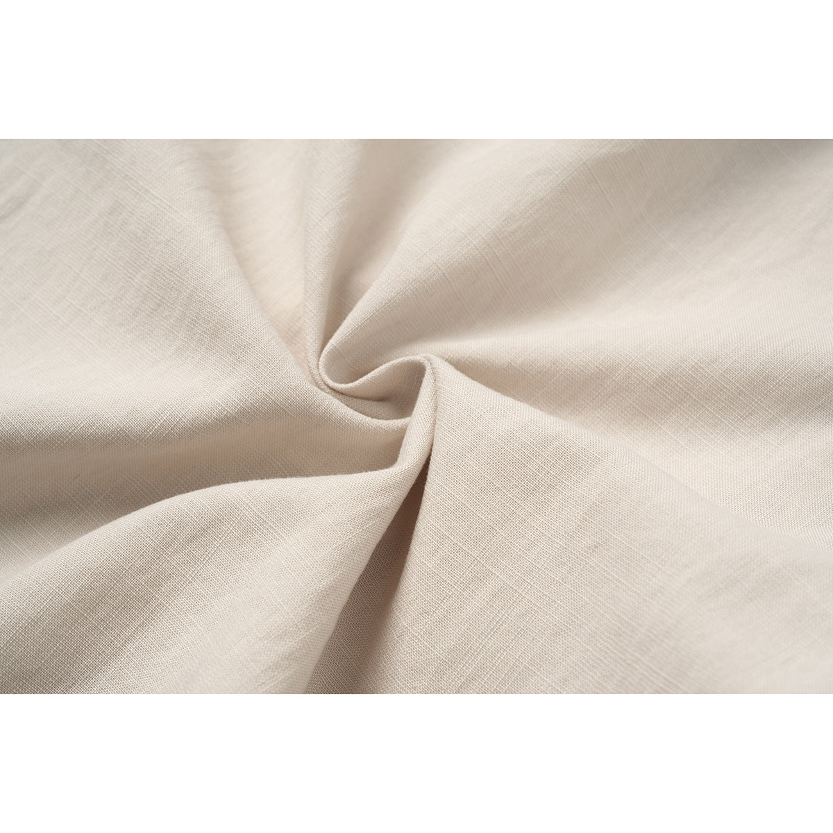 Macro view of light beige woven-looking fabric gathered into soft folds.