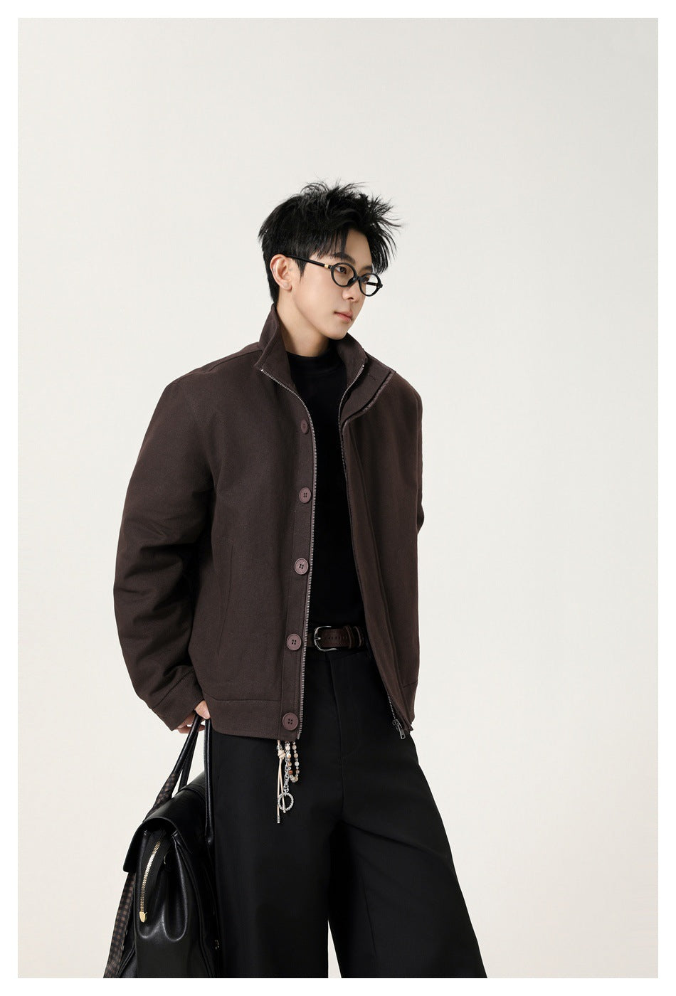 Model wearing a dark brown stand-collar jacket with a buttoned front and zipper.