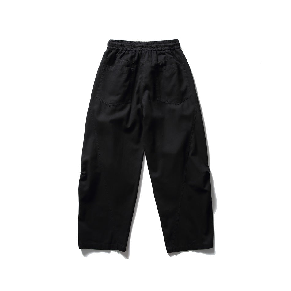 Black wide-leg pants back view with two patch back pockets and curved leg seams