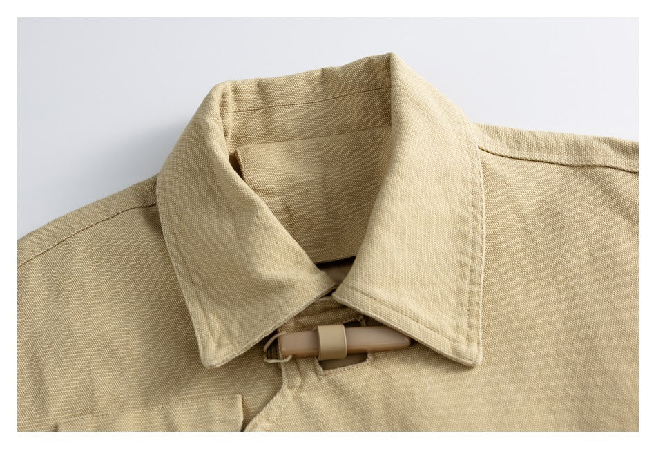 Close-up of a sand-colored jacket collar and tan toggle closure.