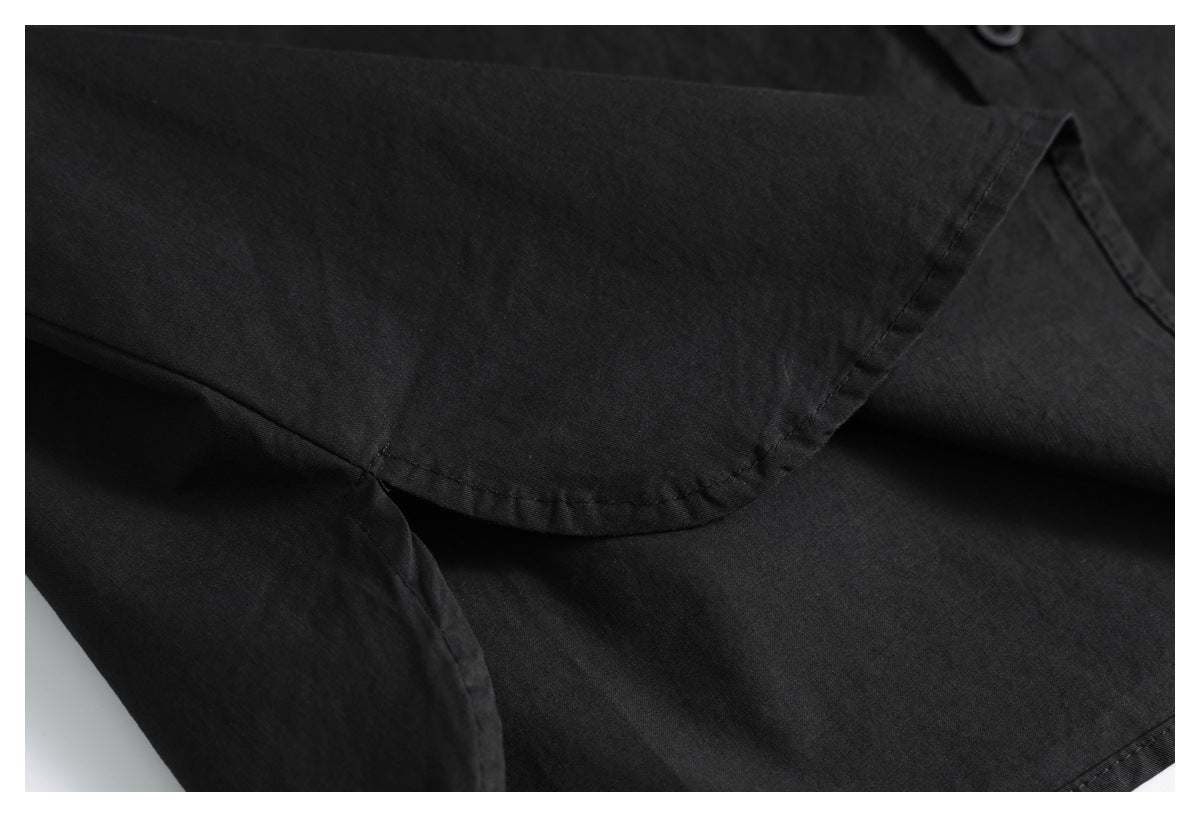 Close-up of the black shirt's sleeve and stitched cuff edge.