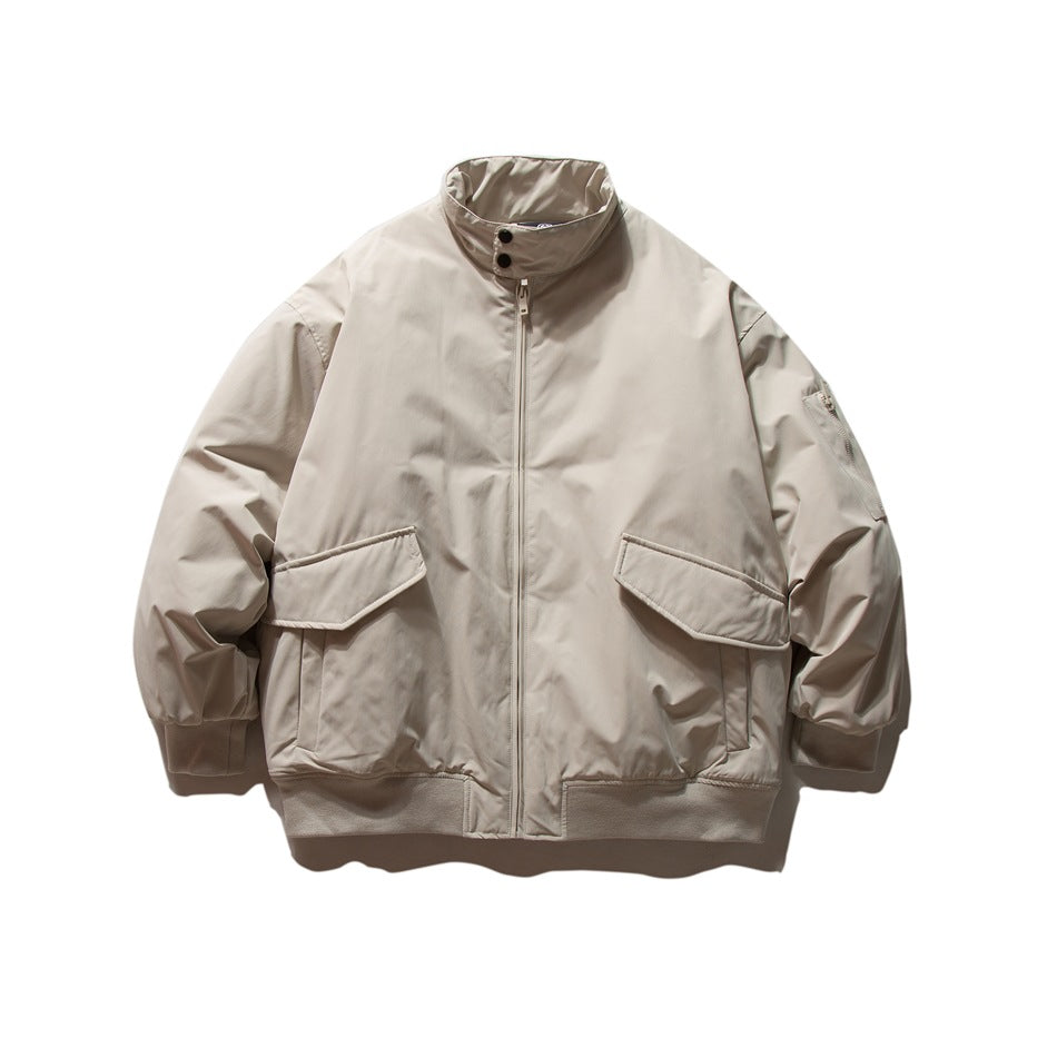 Beige stand-collar zip jacket with large flap pockets and ribbed cuffs and hem, flat lay front view