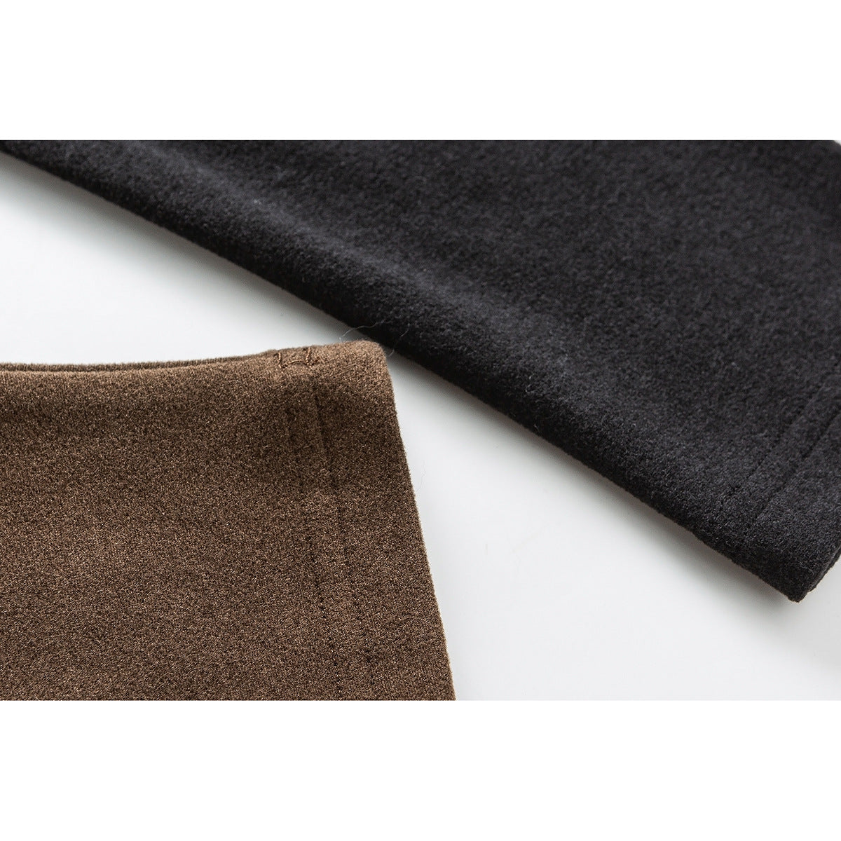 Close-up of brown and charcoal fabric panels with finished edges.