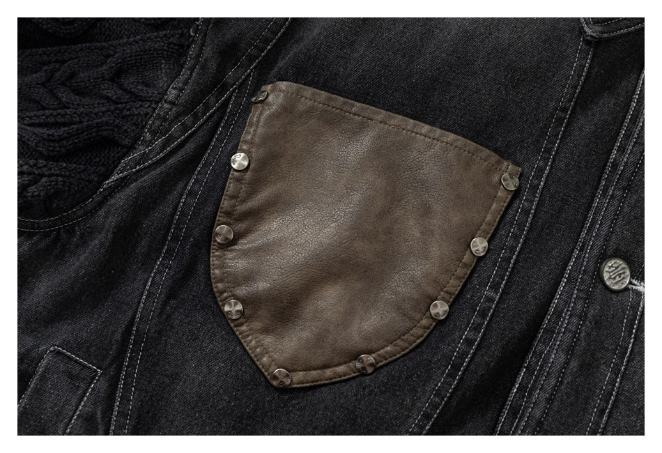 Close-up of a dark denim jacket with a brown leather chest pocket secured by metal buttons.