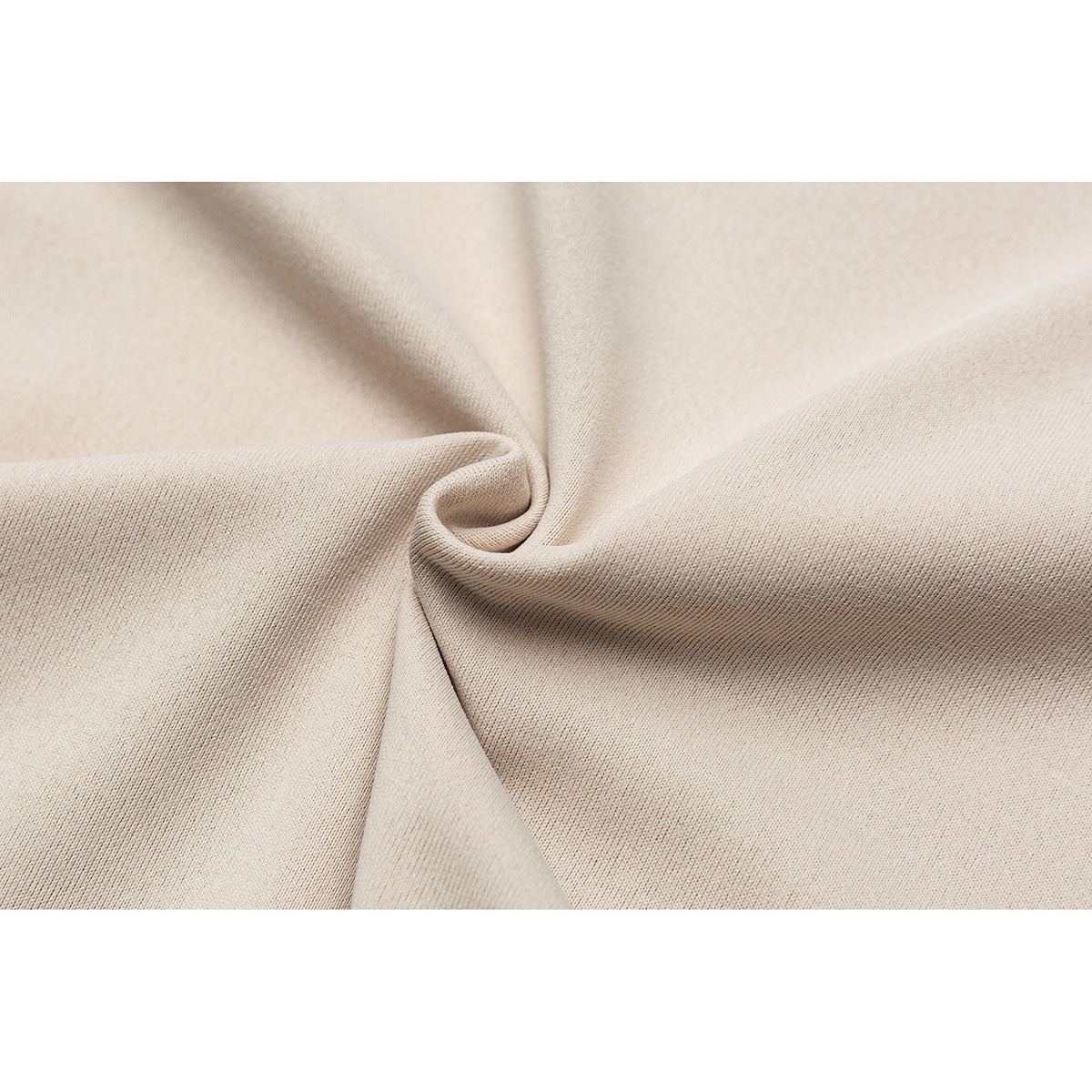 Close-up of beige fabric gathered into a fold, showing its surface and weave.