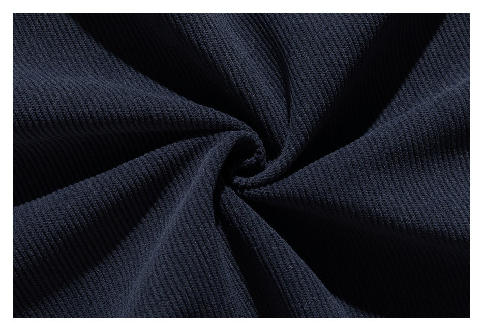 Close-up of dark navy ribbed fabric gathered into folds.