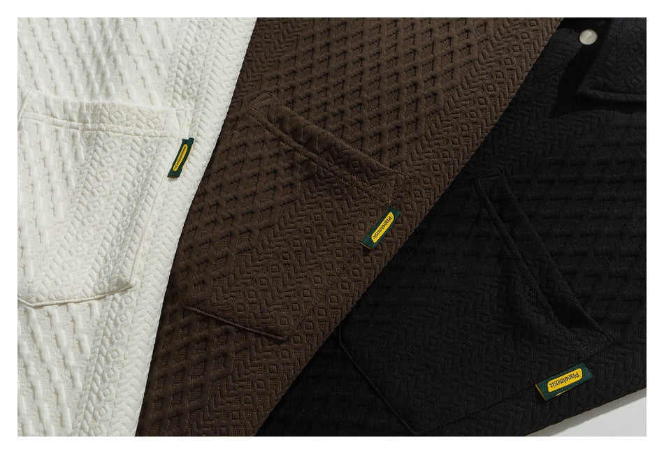 Three textured jackets in white, dark brown, and black, shown overlapping with small sewn labels.