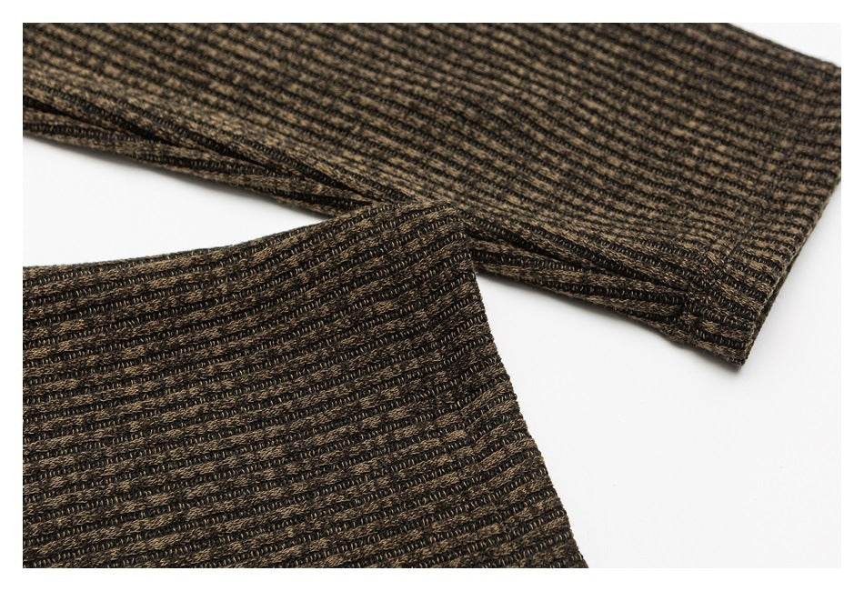 Close-up of the brown and black textured shirt fabric and finished sleeve cuffs.