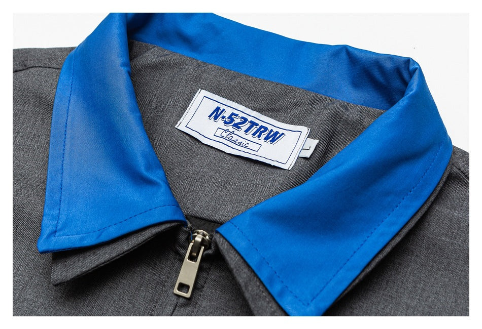Close-up of the jacket's bright blue collar, zipper, and sewn-in brand label.