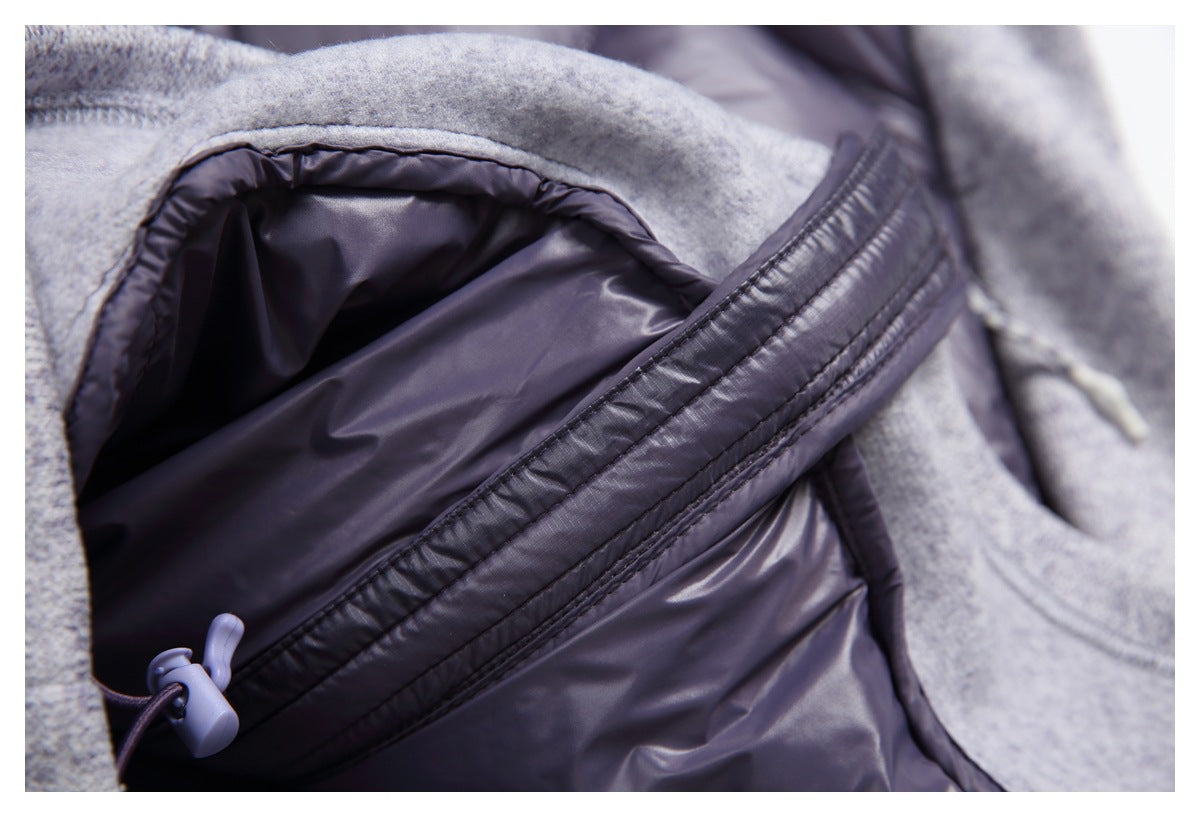 Close-up of the jacket’s plum lining, gray knit edge, and gathered drawcord detail.