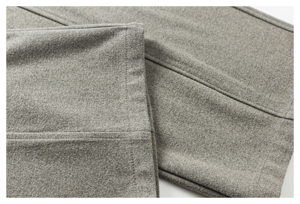 Close-up of gray pant legs showing stitched seams and finished hems.