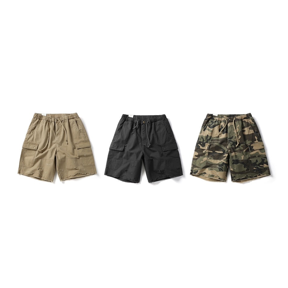 Three pairs of cargo shorts shown from the front in tan, black, and camouflage colorways.