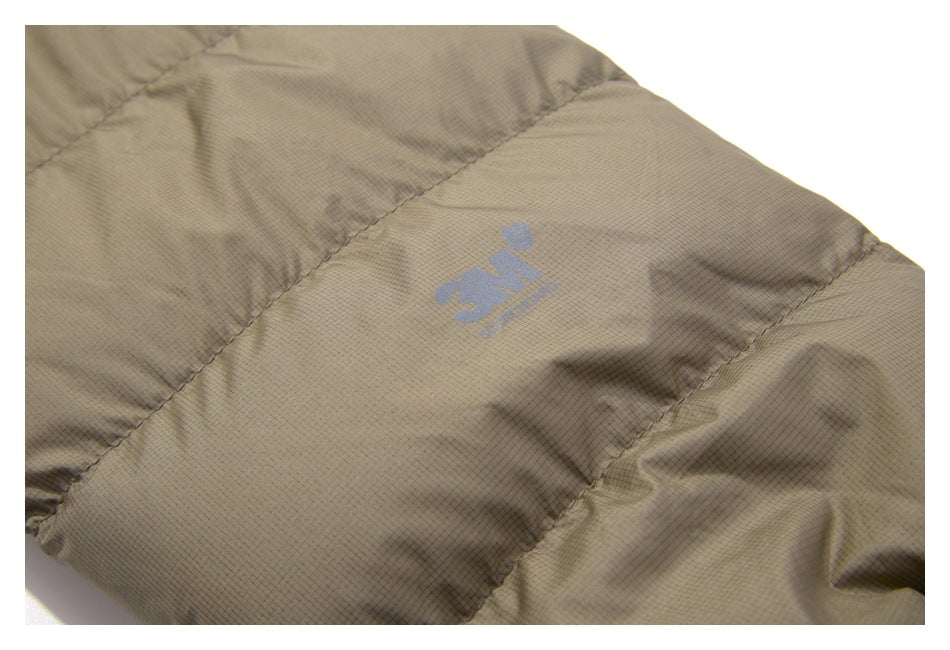 Close-up of a tan jacket panel with a small blue logo on the textured fabric.