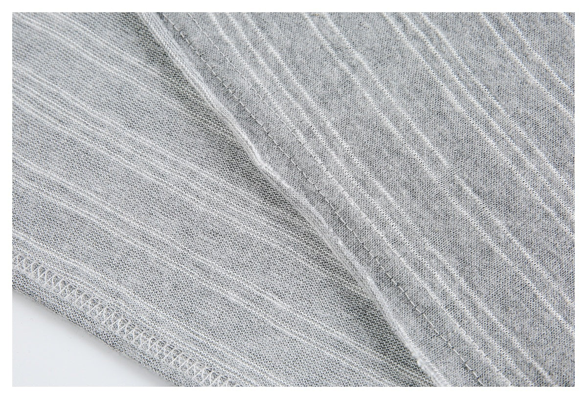 Inside seam and overlock stitching on gray knit fabric with thin white stripes.