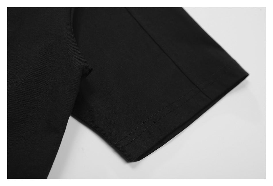 Close-up of a black garment sleeve with a double-stitched hem.