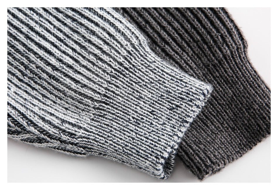 Close-up of ribbed sleeve cuffs on light gray and charcoal sweaters.