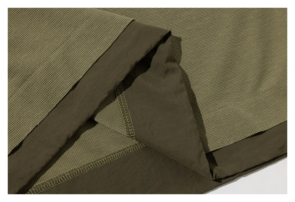 Close-up of the shirt’s inside hem and overlock stitching.