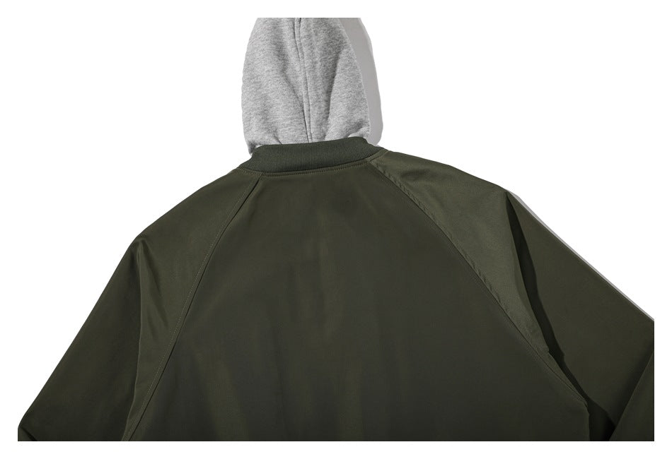 Back view of an olive jacket with raglan seams and a gray hood visible above the collar.