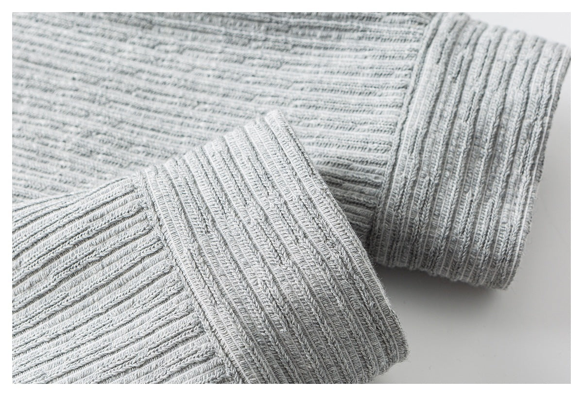 Close-up of the light gray sweater's wide rib-knit cuff and sleeve.