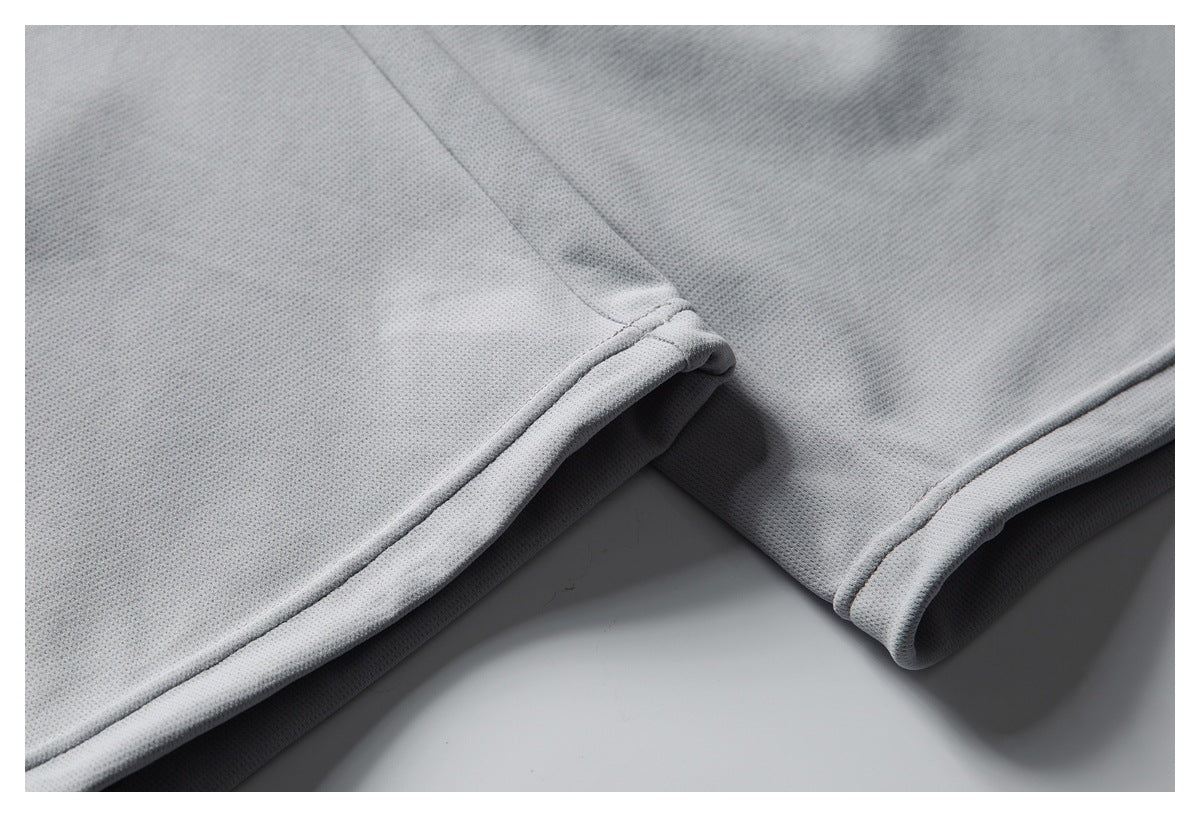 Close-up of two finished hems on a light gray mesh garment.