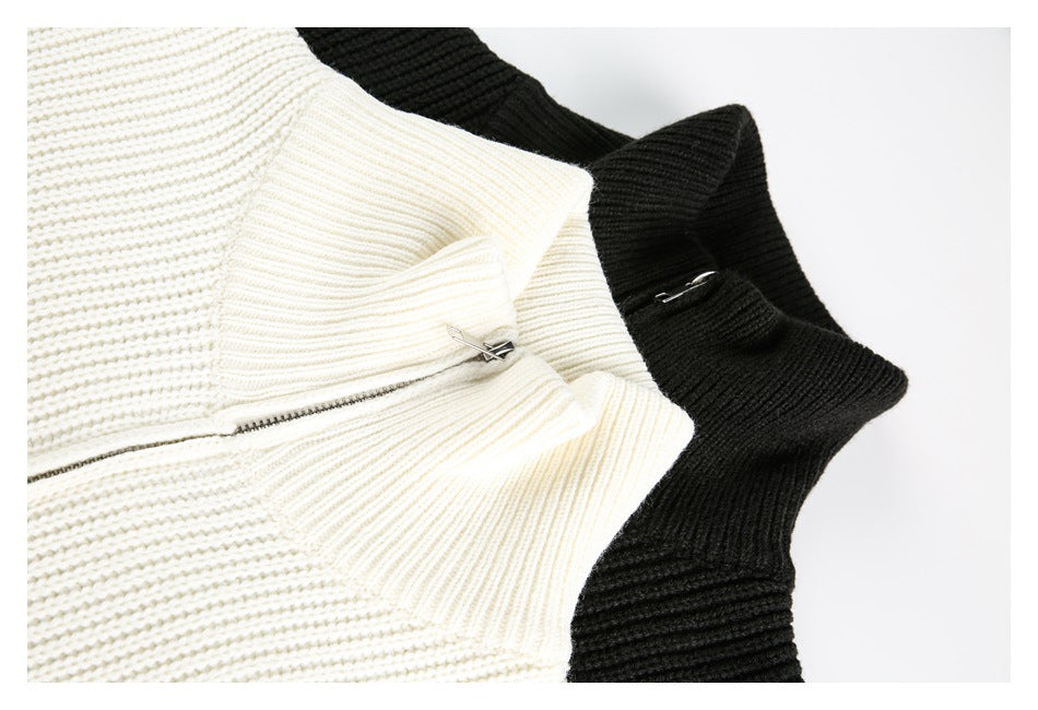 Close-up of cream and black ribbed sweater collars and silver zipper details.