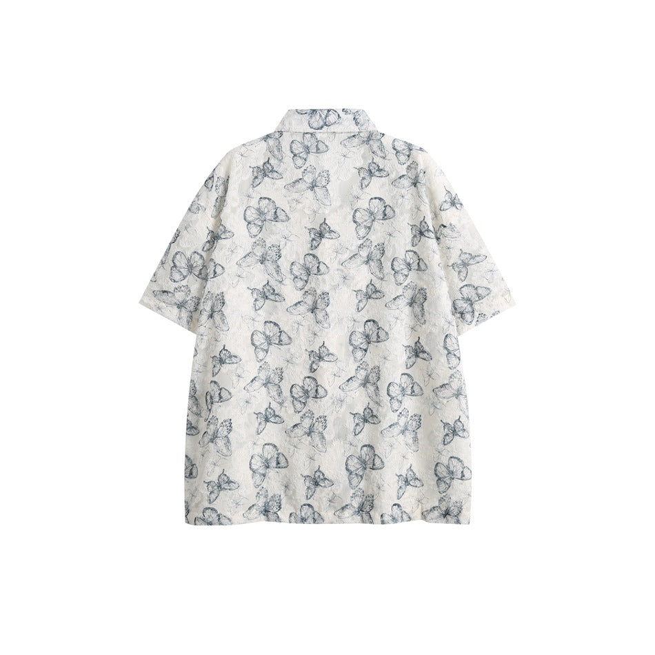 Back view of an ivory short-sleeve shirt with blue-gray butterfly and floral patterns.
